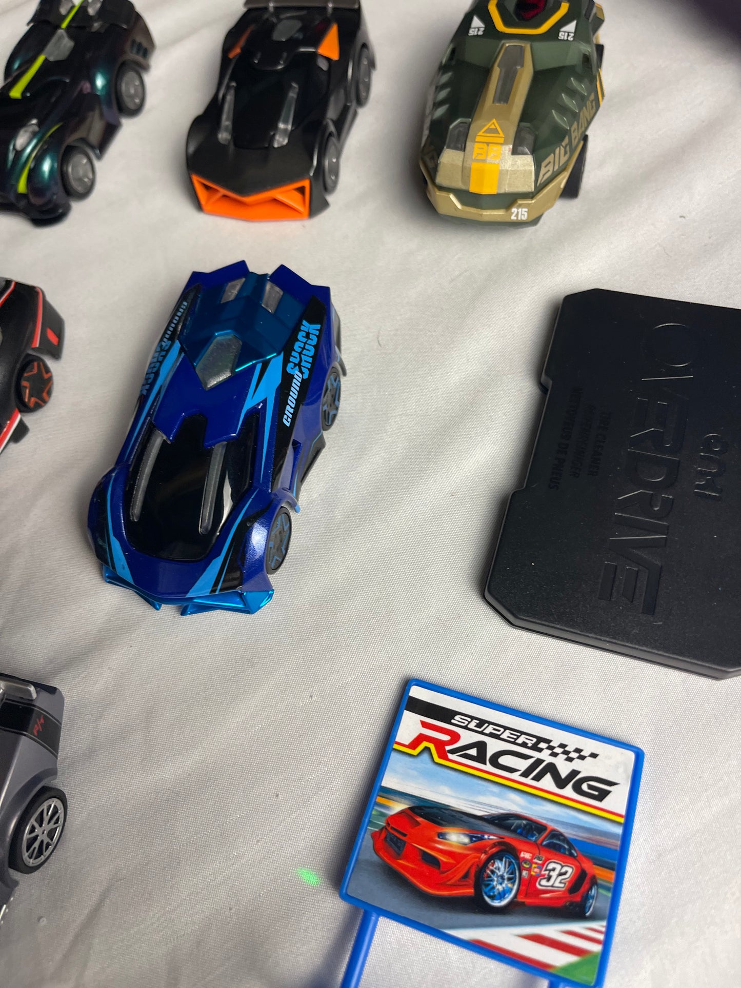 Anki Overdrive Lot Of 11 Vehicles & 2 Charger Docks 2 tire pads & some prop accessories